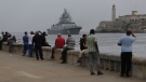 People watch the Russian Navy Admiral Gorshkov frigate arrive at the port of Havana, Cuba, Wednesday, June 12, 2024. A fleet of Russian warships reached Cuban waters on Wednesday ahead of planned military exercises in the Caribbean. (Ariel Ley / AP Photo)