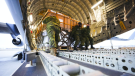 Royal Canadian Air Force personnel load non-lethal and lethal aid at CFB Trenton, Ontario, bound for Ukraine, on Monday, March 7, 2022. THE CANADIAN PRESS/Sean Kilpatrick