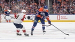 Florida Panthers' Sam Bennett (9) and Edmonton Oilers' Philip Broberg (86) battle for the puck during second period Game 3 action of the NHL Stanley Cup final in Edmonton on Thursday, June 13, 2024.THE CANADIAN PRESS/Jason Franson