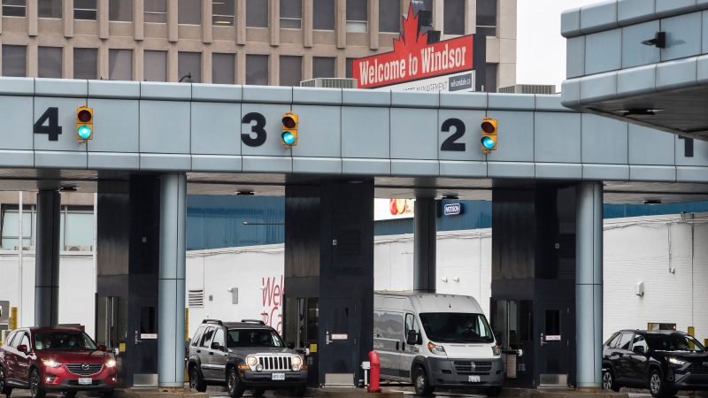 Vehicles exit the customs booths at the Windsor Detroit Tunnel in Windsor, Ont., on Saturday, December 18, 2021. (Source: THE CANADIAN PRESS/Fred Thornhill)