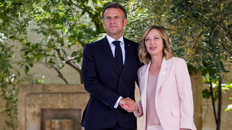 French President Emmanuel Macron, left, is welcomed by Italian Prime Minister Giorgia Meloni during a G7 world leaders summit at Borgo Egnazia, Italy, June 13, 2024. (AP Photo/Luca Bruno)