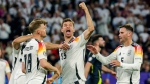 Germany's Thomas Mueller, centre, celebrates during the Group A match between Germany and Scotland at the Euro 2024 soccer tournament in Munich, Germany, Friday, June 14, 2024. (Christian Charisius/dpa via AP)