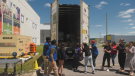 Donors helping to unload over 210,000 pounds of food for the Ottawa Food Bank on Saturday, the largest donation in its history. (Sam Houpt/CTV News Ottawa)