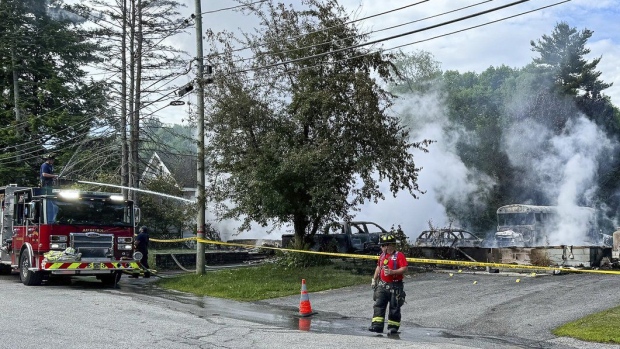 Auburn firefighters hose down the remains of home in Auburn, Maine, early Saturday, June 15, 2024. (Russ Dillingham/Sun Journal via AP)