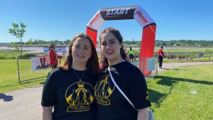 Nadine Larche and her daughter Mia stand by the finish line at Sunday's Three Fathers Memorial Run in Moncton. (Derek Haggett/CTV Atlantic)