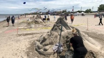 Sharon Nesbitt sculpts her sand castle at Wasaga Beach on June 16, 2024 (David Sullivan/CTV News). 