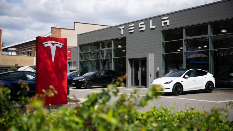 Cars are parked at a Tesla dealership in Berlin Tuesday, April 23, 2024. (Sebastian Christoph Gollnow / dpa via AP)