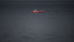 A paddler sunbathes on their standup paddleboard on the Ottawa River near Britannia Beach in Ottawa, Tuesday, June 18, 2024. THE CANADIAN PRESS/Justin Tang