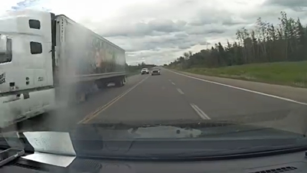 Dangerous attempt to pass multiple vehicles in the oncoming lane on Highway 11, just east of Kapuskasing, Ont., on June 19, 2024. (Ontario Provincial Police/Image from video)