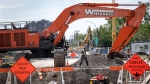 Crews continue to work to repair a major water main break and five other weak spots in Calgary, Saturday, June 22, 2024. (THE CANADIAN PRESS/Jeff McIntosh)