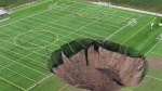 A 30-metre-wide sinkhole, caused by a nearby mine collapsing, swallowed part of a soccer field in Alton, Ill., on June 26, 2024. (source: 618 Drone Service via Storyful)