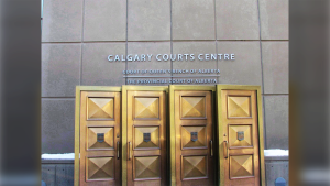 The sign at the Calgary Courts Centre in Calgary, Alberta is shown on January 5, 2018. A judge has approved a $9.5-million settlement for complainants in a class action lawsuit that accused the Calgary Stampede of allowing a performance school staffer to sexually abuse young boys. THE CANADIAN PRESS/Bill Graveland