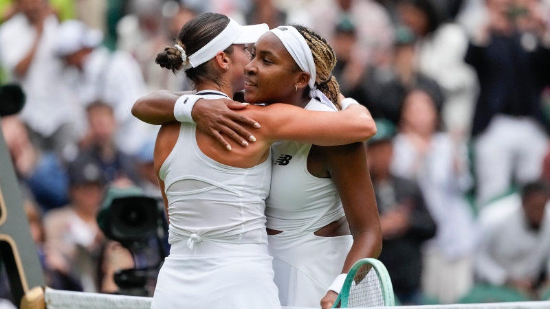 Coco Gauff, right, of the United States embraces compatriot Caroline Dolehide following their first round match of the Wimbledon tennis championships in London, Monday, July 1, 2024. (AP Photo/Alberto Pezzali)