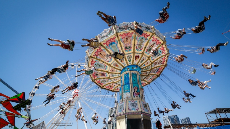 Visitors enjoy a ride on the midway as they attend the Calgary Stampede in Calgary, Tuesday, July 12, 2022. (THE CANADIAN PRESS/Jeff McIntosh) 