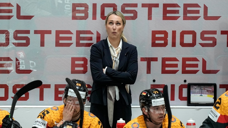 Germany's assistant coach Jessica Campbell stands behind players at the German bench during the 2022 World Hockey Championship on May 16, 2022. (Martin Meissner/AP Photo)
