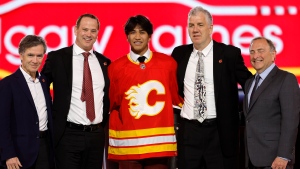 Zayne Parekh, centre, poses after being selected by the Calgary Flames during the first round of the NHL hockey draft Friday, June 28, 2024, in Las Vegas. (THE CANADIAN PRESS/AP, Steve Marcus)
