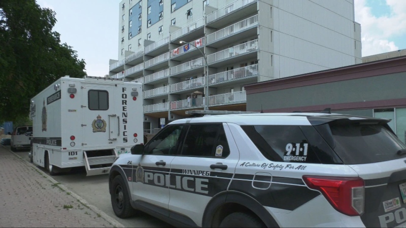 Winnipeg police vehicles are pictured at a Kennedy Street apartment complex during a homicide investigation on July 7, 2024 (Alexandra Holyk/CTV News Winnipeg)