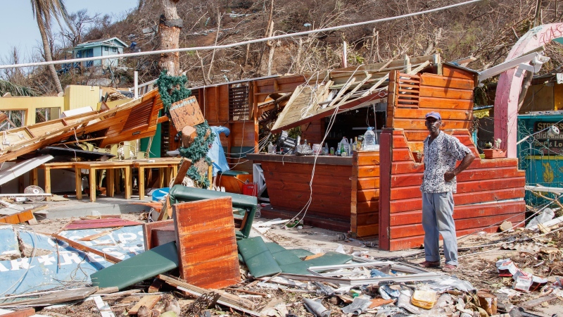 A man stands next to a business destroyed by hurricane Beryl in Clifton, Union Island, St. Vincent and the Grenadines on July 4, 2024. (Lucanus Ollivierre / AP Photo)