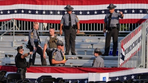 Law enforcement officers work at the campaign rally site for Republican presidential candidate former President Donald Trump is empty and littered with debris July 13, 2024, in Butler, Pa. (Evan Vucci/AP)