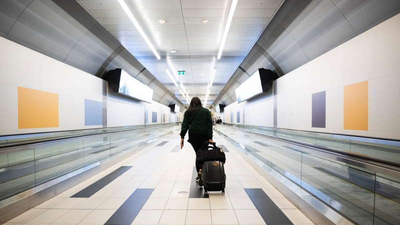 A traveller is shown at Billy Bishop Airport in Toronto on July 19, 2024. (Christopher Katsarov / The Canadian Press) 