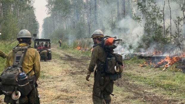Pioneer Peak Hotshots from Alaska and an Alberta Wildfire crew from Calgary conduct ignition operations along a containment line to secure a side of HWF136 in the Semo Wildfire Complex on July 21, 2024. (Photo: Alberta Wildfire)