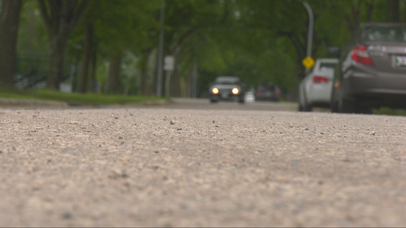 A car is seen driving down a Winnipeg street on July 23, 2024. (Jeff Keele/CTV News Winnipeg)