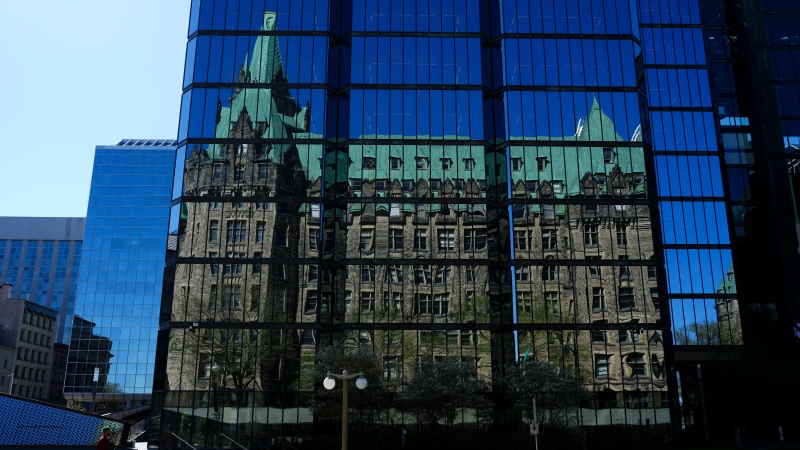 The Confederation building on Parliament Hill is reflected in the windows of the Bank of Canada in Ottawa on Monday, May 6, 2024.  THE CANADIAN PRESS/Sean Kilpatrick