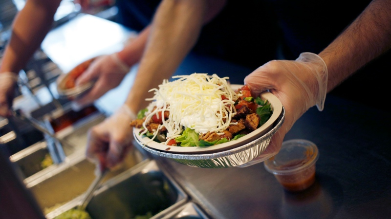 An employee prepares a burrito bowl at a Chipotle Mexican Grill Inc. restaurant in Louisville, Kentucky, in February 2019. (Luke Sharrett / Bloomberg / Getty Images / File via CNN Newsource)