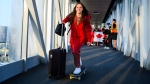 14-year old Canadian Olympic athlete in skateboarding, Fay DeFazio Ebert, skates down to board the plane headed to the 2024 Paris Olympics, in Toronto on Wednesday, July 24, 2024. (Christopher Katsarov / The Canadian Press)
