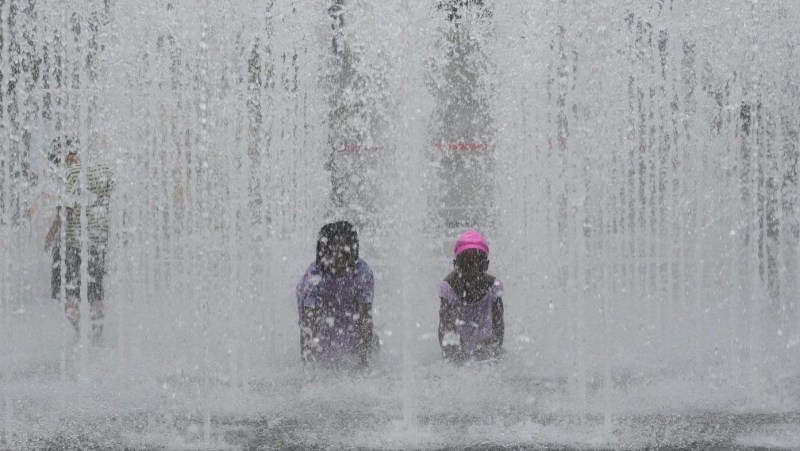 Children cool themselves off in a public fountain in Seoul, South Korea, Thursday, July 25, 2024. (AP Photo/Ahn Young-joon)