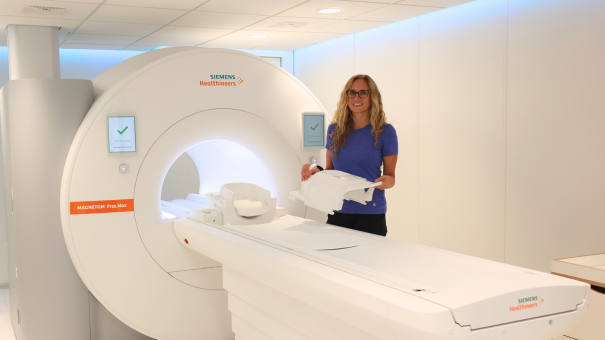 Medical Radiation Technologist Michelle Cress, standing beside the MAGNETOM Free Max 0.55T MRI. (Source: LHSC)