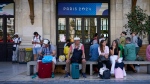 Travellers wait outside the Gare de Bordeaux Saint-Jean at the 2024 Summer Olympics in Bordeaux, France on July 26, 2024. (Moises Castillo / AP Photo)
