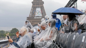 Spectators wait for the start of the opening ceremony of the 2024 Summer Olympics in Paris, France, Friday, July 26, 2024. (Thibault Camus / AP Photo)