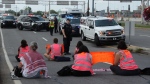For the third day in a row, Last Generation protesters blocked traffic near the Montreal airport (YUL) by gluing their hands to the pavement. (The Last Generation)
