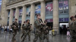 Soldiers patrol outside Gare du Nord train station at the 2024 Summer Olympics, Friday, July 26, 2024, in Paris, France. (AP Photo/Mark Baker)