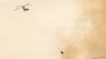 A helicopter battles the Shetland Creek wildfire on Sunday, July 21, 2024. (BC Wildfire Service)