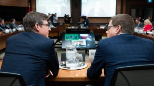 Galen G. Weston of Loblaw Companies Limited, left, speaks with Michael Medline, President and CEO of Empire Company Limited as they wait to appear as witnesses at the Standing Committee on Agriculture and Agri-Food (AGRI) investigating food price inflation in Ottawa, Wednesday, March 8, 2023. THE CANADIAN PRESS/Spencer Colby