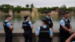 Police officers patrol along the Seine in Paris, France, during the opening ceremony of the 2024 Summer Olympics, Friday, July 26, 2024. (AP Photo/Rebecca Blackwell)
