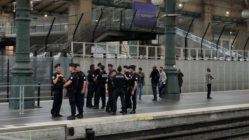 Police officers patrol inside the Gare du Nord train station at the 2024 Summer Olympics in Paris France on Friday, July 26, 2024. (AP Photo/Mark Baker)