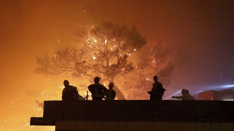 Firefighters gather near the wildfire in Tucepi, Croatia, late Tuesday, July 30, 2024. (Ivo Ravlic, Cropix via AP)