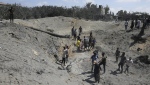 Palestinians search for bodies and survivors in a site hit by an Israeli bombardment on Khan Younis, southern Gaza Strip, Saturday, July 13, 2024. (AP Photo/Jehad Alshrafi)