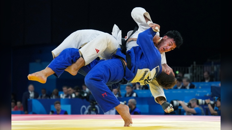 Canada's Shady Elnahas, top, competes against Switzerland's Daniel Eich during the Men's 100 Kg Judo in Paris on Aug. 1, 2024. (Nathan Denette / The Canadian Press)
