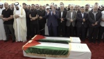 This video grab shows senior Hamas official Khalil al-Hayya, centre, praying near the coffin of Hamas leader Ismail Haniyeh and his bodyguard during the funeral prayers in Doha, Qatar, Friday Aug. 2, 2024. (Qatar TV via AP)