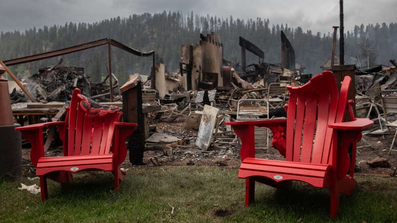 Melted chairs are shown outside of the burned Maligne Lodge after wildfires encroached into Jasper, Alta., on Friday, July 26, 2024. Wildfires encroaching into the townsite of Jasper forced an evacuation of the national park and have destroyed over 300 of the town's approximately 1,100 structures, mainly impacting residential areas. (Amber Bracken / The Canadian Press) 