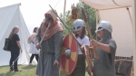 Visitors to the Viking Village test out weapons and armour at the Icelandic Festival of Manitoba in Gimli on Aug. 5, 2024. (Zach Kitchen/CTV News Winnipeg)