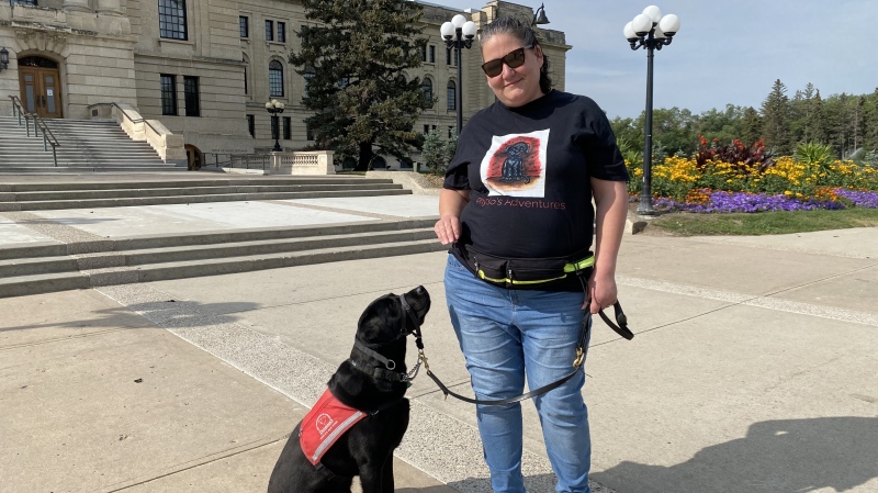 Charlene Izuka with her service dog in Regina. Izuka has published a children's book that explains the need for service dogs and their roles. (Hallee Mandryk/CTV News)