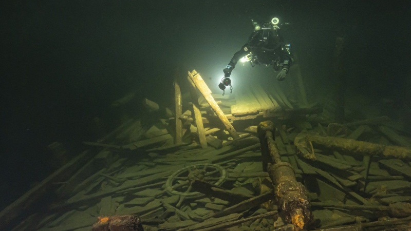 A diver from the Polish Baltictech team inspects wreckage of a 19th century sailing ship that the team discovered July 11, 2024, on the Baltic seabed about 37 kilometres ) south of the Swedish isle of Öland. (Marek Cacaj/Baltictech via AP)