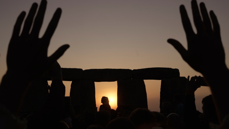 People gather at the ancient stone circle Stonehenge to celebrate the Summer Solstice. (AP Photo/Kin Cheung)