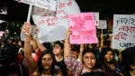 Students join other protesters in a midnight rally protesting against the murder of a 31 year old post-graduate trainee demanding proper investigation in Kolkata, India, Wednesday, Aug. 14, 2024. (AP Photo/Bikas Das)