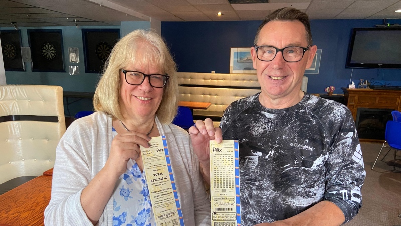 Jane and David Forrest posing with their Lotto Max Maxmillions winning ticket and receipt. Aug. 20, 2024. (Dylan Dyson/CTV News Ottawa)